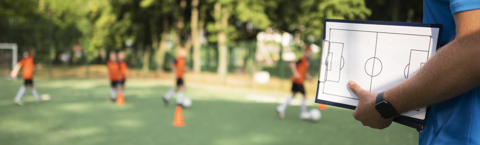 Football trainer teaching his pupils