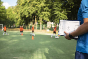 Football trainer teaching his pupils